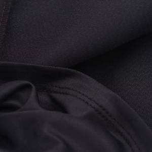 Detail of high-quality double-needle stitching on black knit dress fabric texture