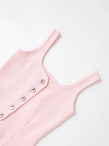 Close-up of pink ribbed knit top featuring modern irregular silver metal buttons