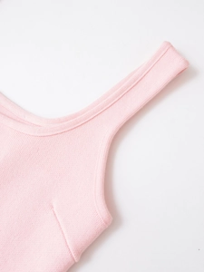 Close-up of fine knit texture and flat seams on the pink sleeveless sweater shoulder