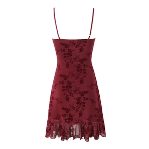 Detail of burgundy floral jacquard dress featuring ruffled hem and slim straps