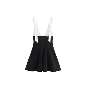 Elegant sleeveless V-neck dress in black and white contrast design with A-line skirt silhouette