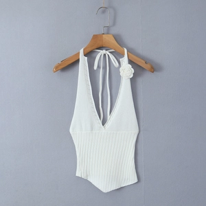 Detail of white ribbed knit halter top with deep V-neck and 3D floral decoration