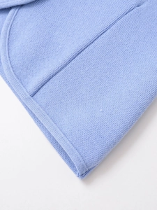 Detail of light blue knitted fabric texture with high-quality stitching and smooth edges