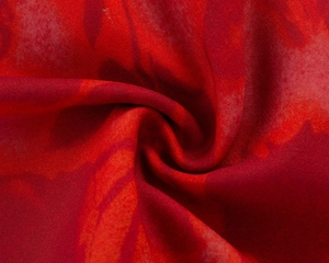 Close-up of lightweight red floral chiffon fabric with a soft pleated texture