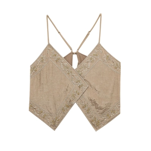 Detail view of champagne silk crop top featuring intricate diamond floral beadwork and thin straps