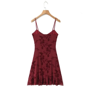 Detail of red floral print dress with delicate lace trim and ruffled hemline