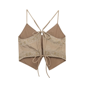 Detailed view of the backless tie design and floral embroidery with metallic sequins