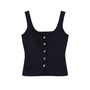 Detail of navy knit vest showing textured fabric and unique silver metal buttons