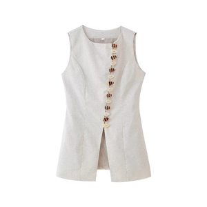 Detailed view of women's sleeveless vest featuring decorative buttons and front slit hem