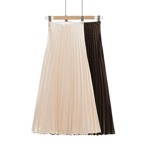 Detail view of premium satin pleated skirts in apricot and deep coffee with silky texture