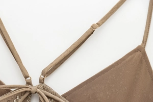 Detail of adjustable straps with gold metal buckles on a vintage brown backless top