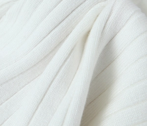 Close-up of white ribbed knit fabric showing soft texture and vertical stripe detail