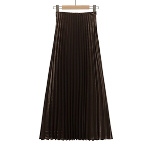 Detail of deep brown pleated skirt with metallic silk texture and fine fabric folds
