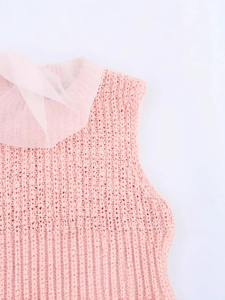 Pink knit vest featuring organza ruffles and a textured sleeveless design for women