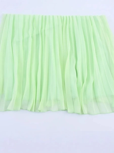 Women high waisted light green pleated chiffon skirt in a minimalist summer style