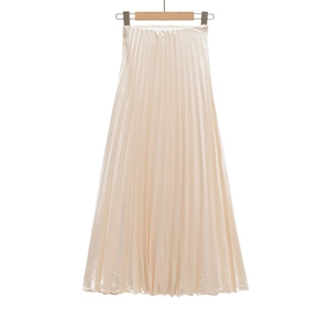 Detailed view of high-waist pleated satin skirt with elastic waistband and champagne gloss