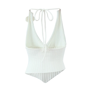 White knit halter top with deep V-neck and floral details for a slim summer look