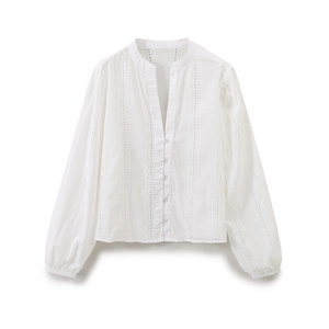 Detail of white V-neck blouse with hollow-out embroidery and lantern sleeves