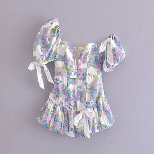 Detail of vintage floral puff sleeve dress with lace bows and ruched waist detail
