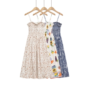 Detailed view of three floral summer dresses with smocked bodices and thin straps