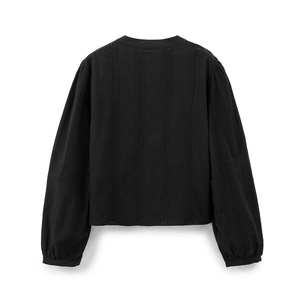 Detailed view of black long-sleeve blouse featuring vertical eyelet embroidery patterns