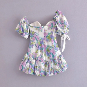 Detail of floral puff sleeves with ribbon bow ties on a French vintage style summer dress