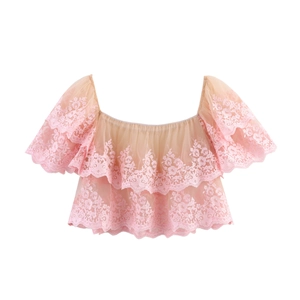 Close-up of pink floral embroidery and layered mesh ruffles on the off-shoulder crop top