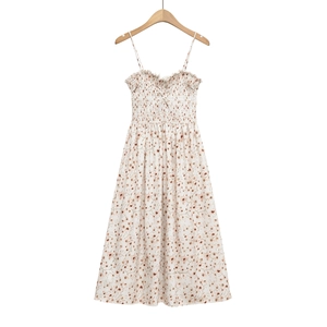 Detail of floral spaghetti strap dress featuring smocked bodice and ruffled neckline