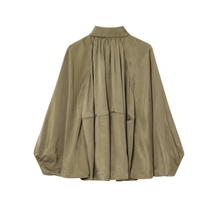 Detailed back view of olive green blouse with elegant pleated texture and balloon sleeves