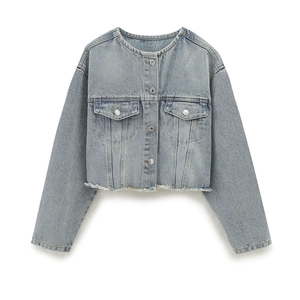 Close-up of raw fringe hem and premium cotton texture on light blue denim jacket