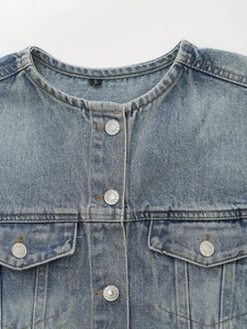 Women's blue denim jacket with round neck and metal buttons in a minimalist spring style
