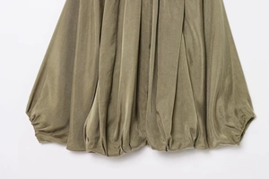Detail of olive green bomber jacket featuring a satin bubble hem with elastic smocking