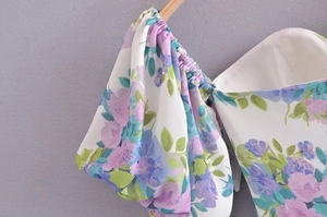 Detail of floral puff sleeves and square neckline on a French vintage style dress