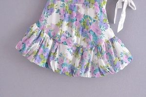 Detailed view of summer floral dress with lace tie-up and pleated puff hemline