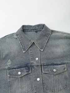 Vintage light blue washed denim jacket with distressed details and metal buttons