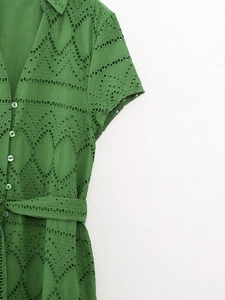 Detail of green eyelet embroidery and round buttons on this French style short sleeve dress