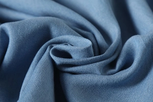 Close-up detail of blue vintage cotton fabric showing texture and twill weave pattern
