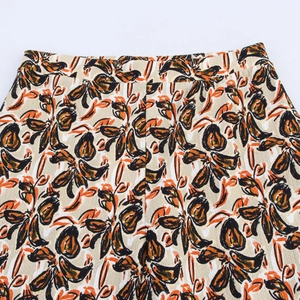 Detail of high waisted pants featuring abstract floral print on textured crepe fabric
