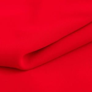 Primo piano della trama del tessuto rosso acceso che mostra la trama fine e il drappeggio