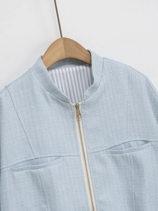 Women's light blue tweed jacket with silver zipper and refined striped lining detail
