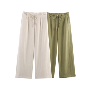 Detailed view of elastic drawstring waistband and breathable fabric on wide leg pants