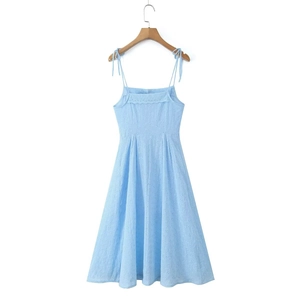 Detail of sky blue sun dress with delicate eyelet embroidery and tie-up shoulder straps