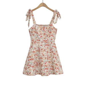 Detailed view of the adjustable tie-up straps on a floral print mini summer dress