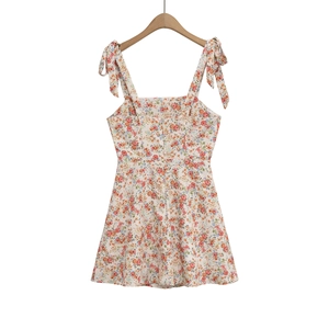 Detail of floral sundress featuring bow-tie straps and a vintage square neckline