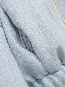 Macro shot of light blue tweed fabric texture with stripe lining and pocket detail