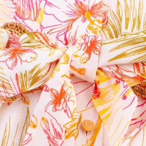 Détail d'une robe d'été avec imprimé hibiscus tropical et boucle de taille ronde en rotin