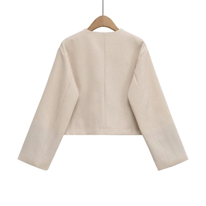 Rear view of a premium short beige tweed jacket featuring minimalist clean tailoring