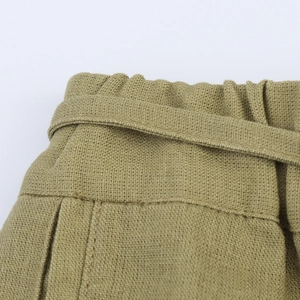 Macro shot of high-waisted drawstring waistband with natural linen fabric texture
