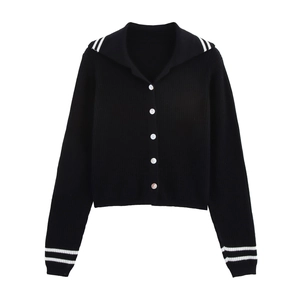 Detail of a black ribbed knit cardigan with white stripes on sailor collar and cuffs