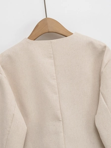 Detailed back view of beige tweed jacket neckline featuring premium textured fabric